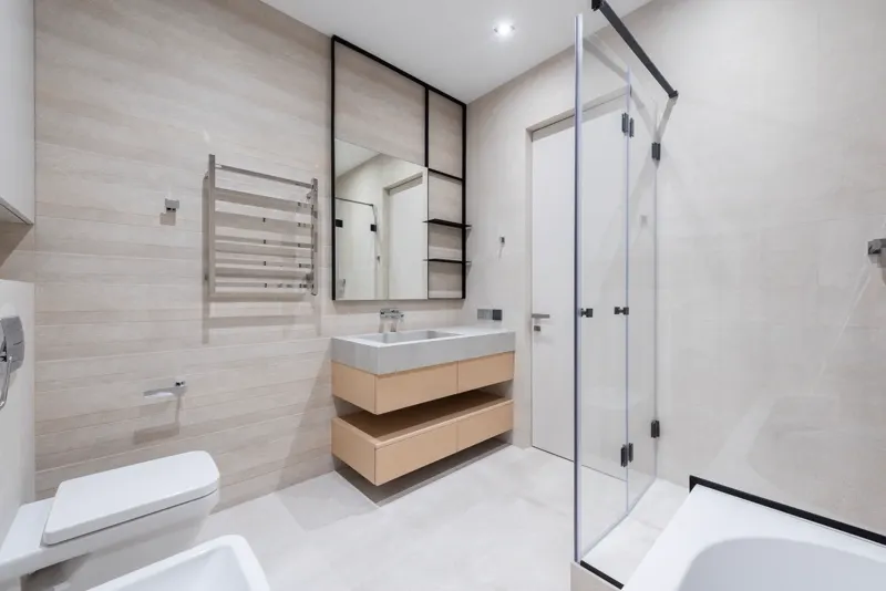 Modern bathroom with soaker tub and glass walk-in shower — representative interior.